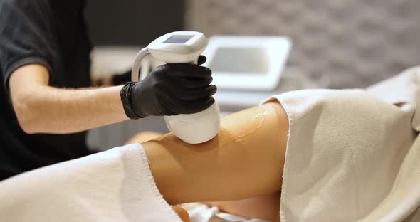 Doctor Doing Ultrasound Liposuction Procedure in Medical Clinic alt