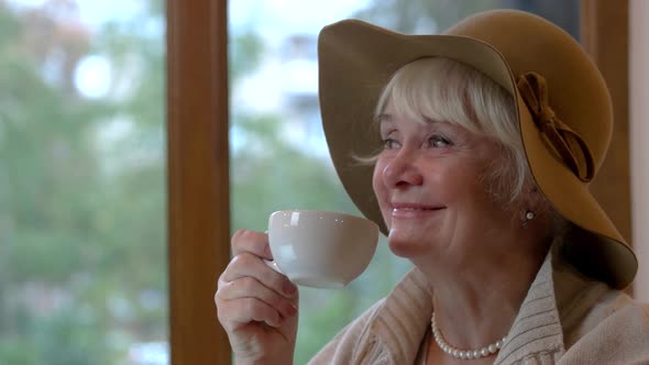 Senior Lady with Cup Smiling alt