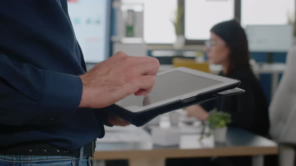 Close Up of Man Using Digital Tablet for Business Project alt