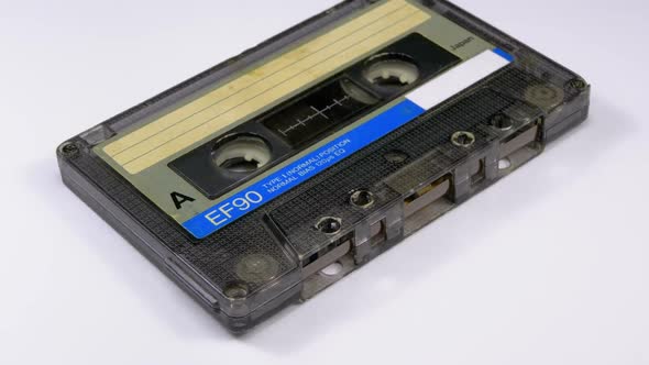 Vintage Audio Cassette Rotates on White Background alt