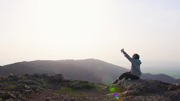 Young Woman Takes Selfie In Scenic Mountains alt
