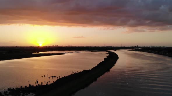 Sunset captured by a drone while swallows are flying true the shot alt