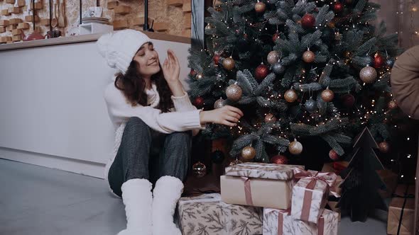 The Happy Girl Smiles Wide After She Has Finished Decorating the Christmas Tree alt