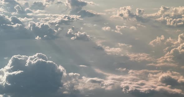 Flying High Above Gray Cloudscape Backlit By Sun Rays View From Cockpit Plane alt