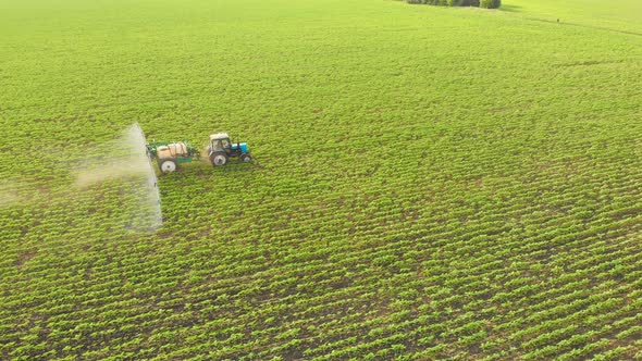 Aerial Top View of Farming Tractor Plowing and Spraying on Agriculture ...