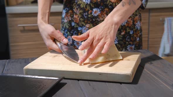Slicing Cheese With Herbs