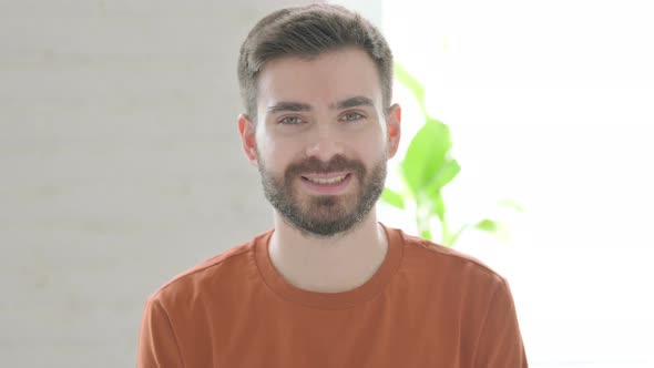 Happy Young Man Smiling at Camera alt