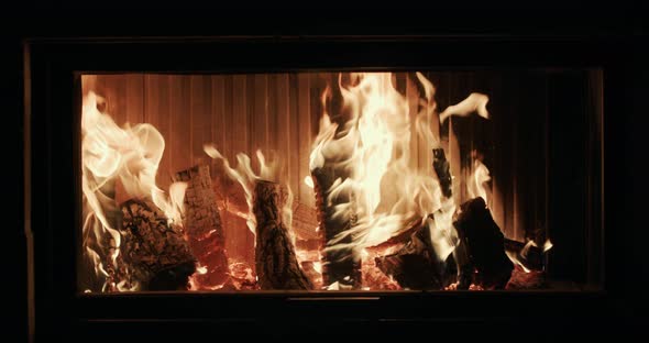 Firewood is Burning in a Modern Stylish Fireplace alt