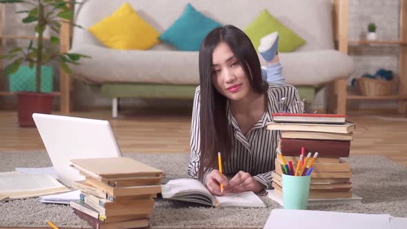 Portrait of a Beautiful Asian Girl Student with Books Looking at the Camera alt