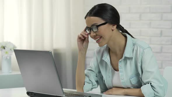Asian Woman in Glasses Chatting in Social Network, Smiling and Answering Message alt