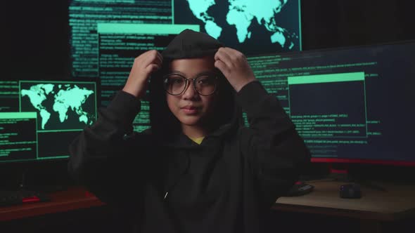 Asian Young Girl Hacker Hacking With Multiple Computer Screens And Pose In Dark Room alt