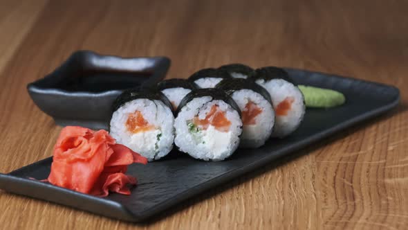 Sushi on a Wooden Table in Restaurant Delicious Japanese Food Sushi Rolls alt