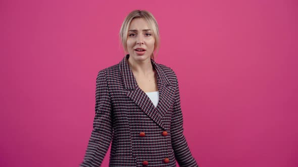 Dissatisfied Young Woman in Profile Looking at the Room and Wondering What She Raised Her Hands Up alt