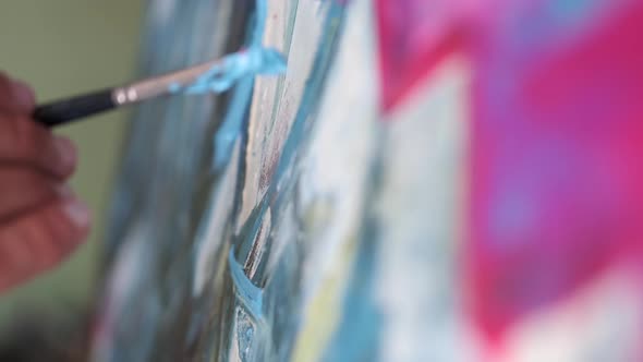 Closeup of an Artist Painting on a Canvas alt