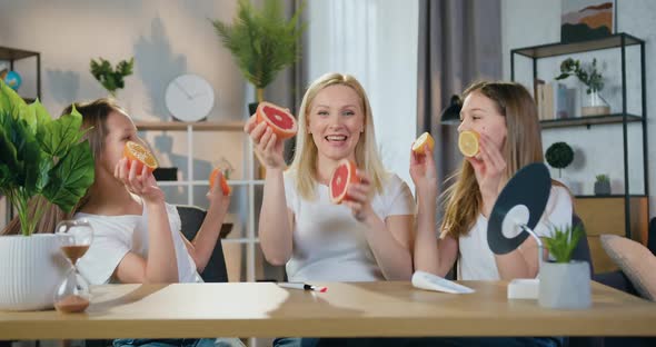 Mother and Her Teen Daughters which Enjoying Joint Leisure at Home, They Taking alt