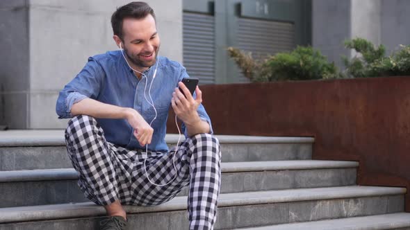 Online Video Chat By Casual Man Sitting on Stairs alt