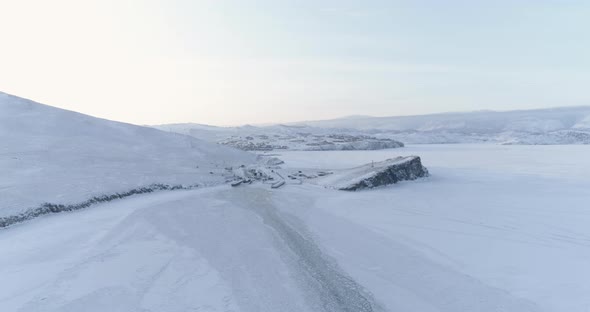 Drone Flies Over the Trail Left by a Ship on the Ice of a Frozen Lake Baikal alt