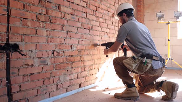 A construction worker works with a puncher copy space.