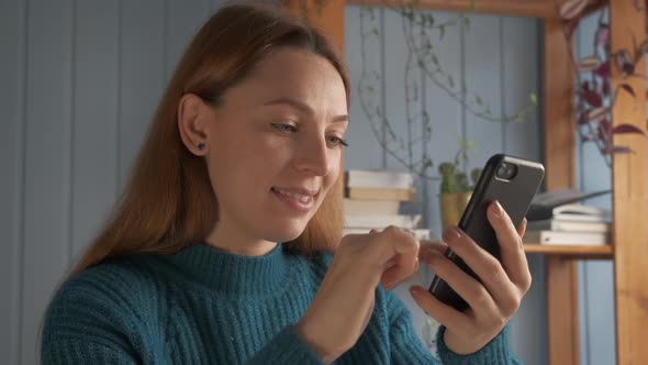 Young Woman Sitting and Chatting with Friend By Messenger Application