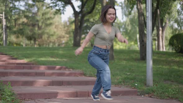 Carefree Laughing Little Woman Running Downstairs in Summer Park Laughing Out Loud alt