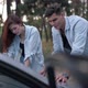 Thoughtful Concentrated Couple Choosing Route Leaning at Car Hood in Forest - VideoHive Item for Sale
