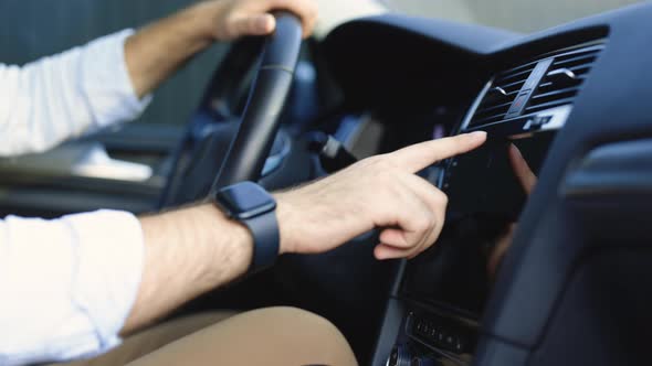 Man Hand Touching Clicking Tapping Sliding Dragging and Swiping on Screen Monitor on Modern Car