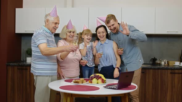 Happy Family Making Birthday Surprise Sending Congratulations Online with Laptop During Coronavirus alt