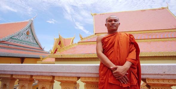 Buddhist Monk With Orange Robe Pray in Temple alt