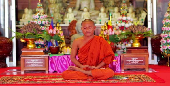 Buddhist Monk With Orange Robe Pray in Temple alt