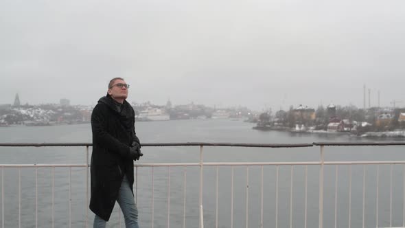 The Person Stands on the Rear Deck of the Ship and Looks at the Winter Landscape alt