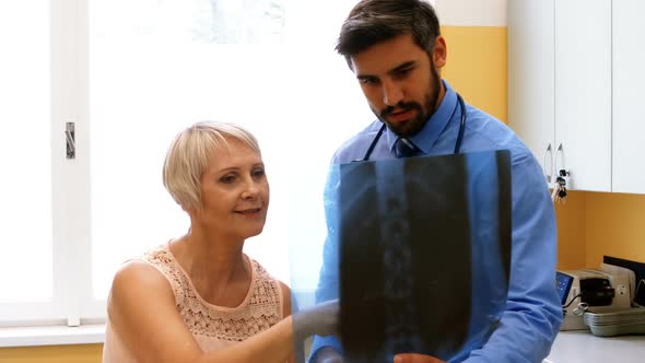 Doctor discussing x-ray with patient alt
