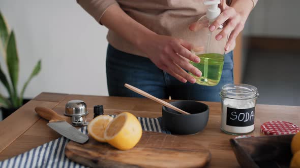 Unrecognizable person adding soap to the bowl with DIY cleaning product. Shot with RED helium camera alt