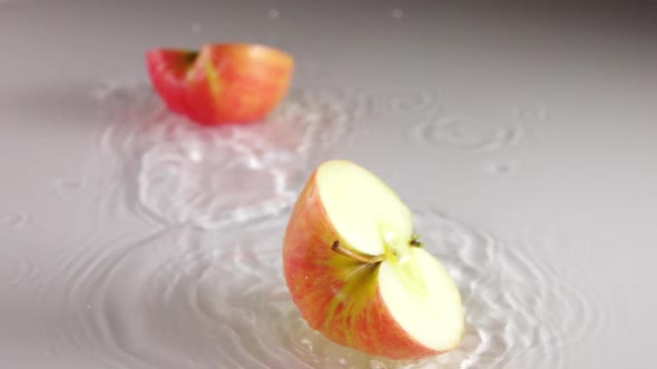 Apple Falls to the Water Surface and Splits in Half