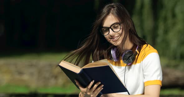 Woman Reading Book in Park