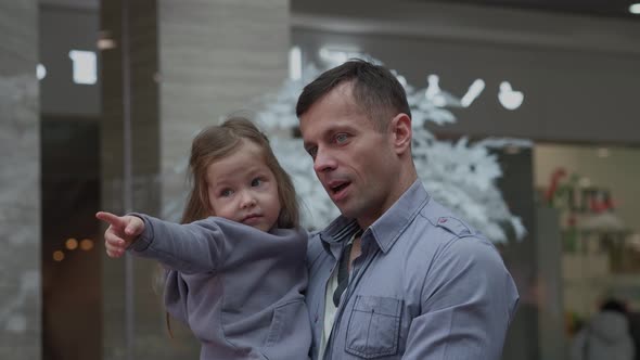 Dad Holding Daughter in His Arms alt