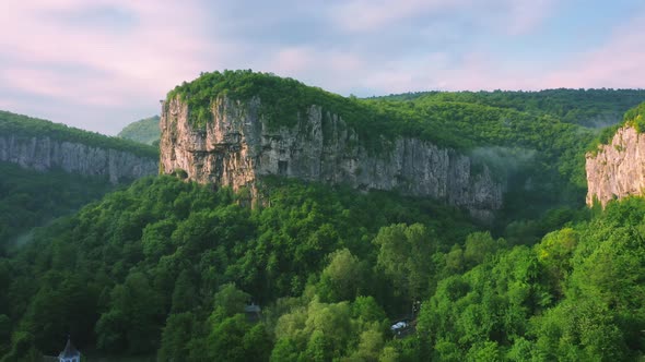 Mountain And Trees In The Cloud And Fog Aerial View On Sunrise alt