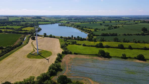 Ariel footage of wind turbine with Boddington reservoir and beautiful English countryside in Northam alt