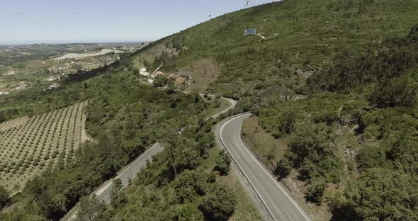 Flying Above The Road On The Lush Mountain In Reguengo Do Fetal In Batalha, Portugal With Distant Vi alt