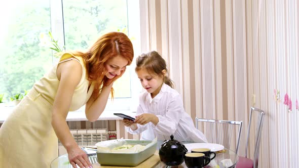 Mom and Daughter Cook Together Take Picture of Quiche Pie for Social Media