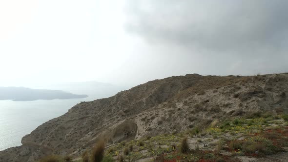 Aerial view of swimming pool with a view of cliff in Santorini island, Greece. alt