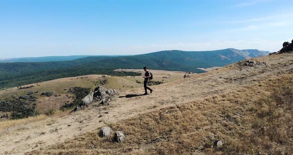 Male Hiker Walking Down The Mountain In Romania At Summer alt