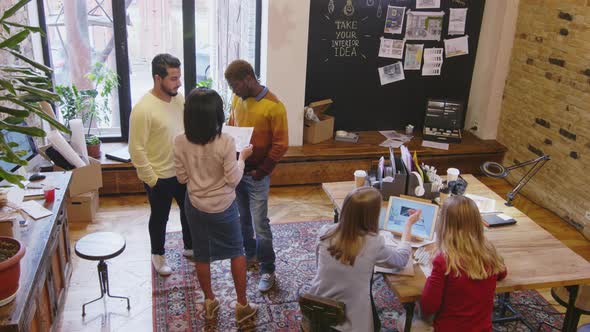 Mixed Raced Designers Working on Interior Project in Office