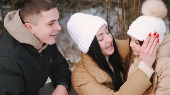 Parents with Daughter Walking in Forest in Winter alt
