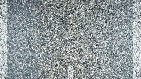 Close up view to an asphalt road with an marking strip alt