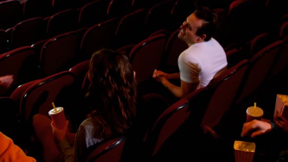 Group of people interacting while watching movie 4k alt