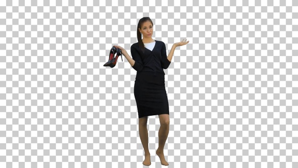 Tired young businesswoman standing barefoot, Alpha Channel