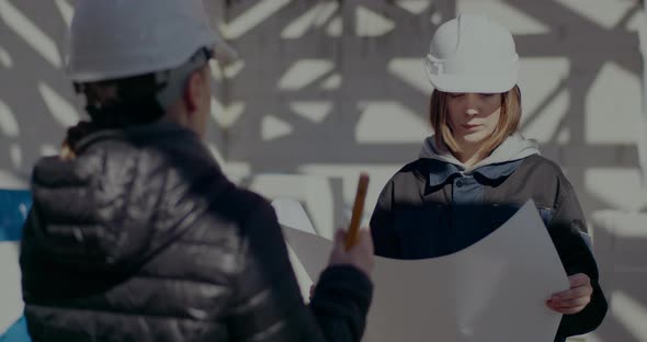 Architect Explaining and Discussing Blueprint with Contractor alt