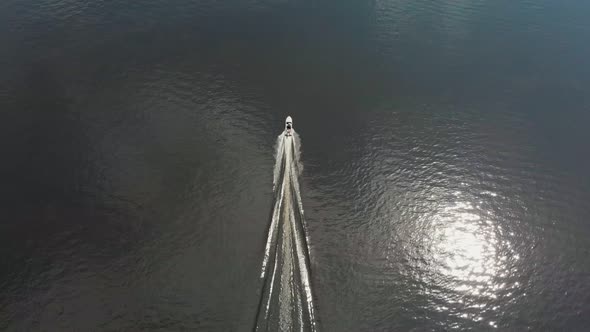 A Man Riding Motor Boat on River alt