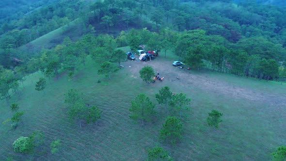 View from above campsite. Group of friends sitting outside enjoying nature