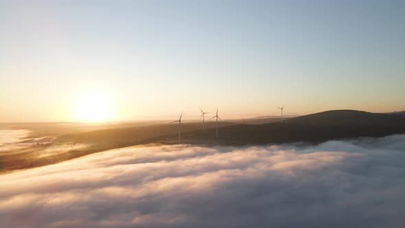 Wind Farm in the Fog at Sunrise alt